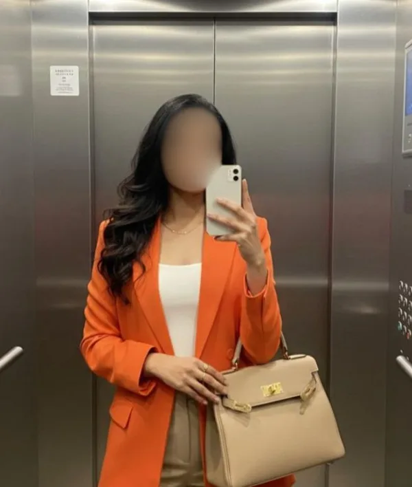 A client in her ICONIK outfit before a work conference, face hidden